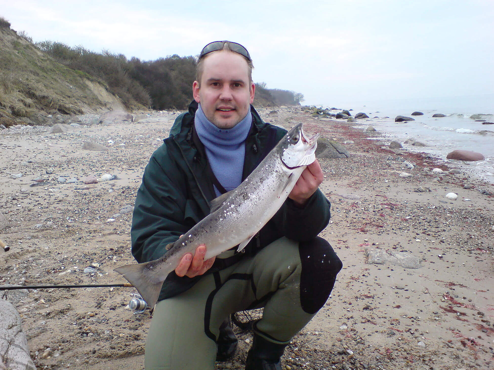 Angler mit Fisch am Ostseestrand